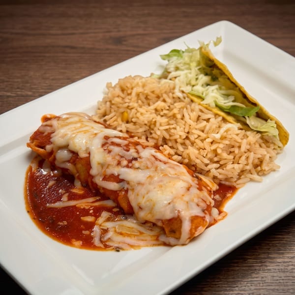 A cheesy enchilada with red sauce, rice, and a taco with lettuce on a white plate.